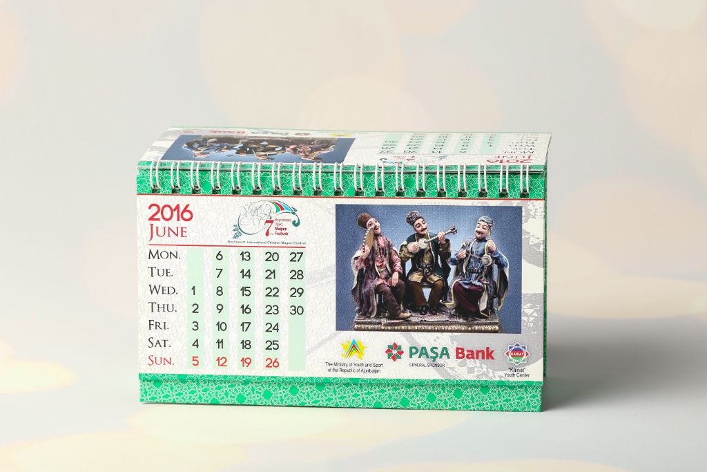 Desk calendar 2016 — June page, photo of mugham trio sculptures, date grid, sponsor logos