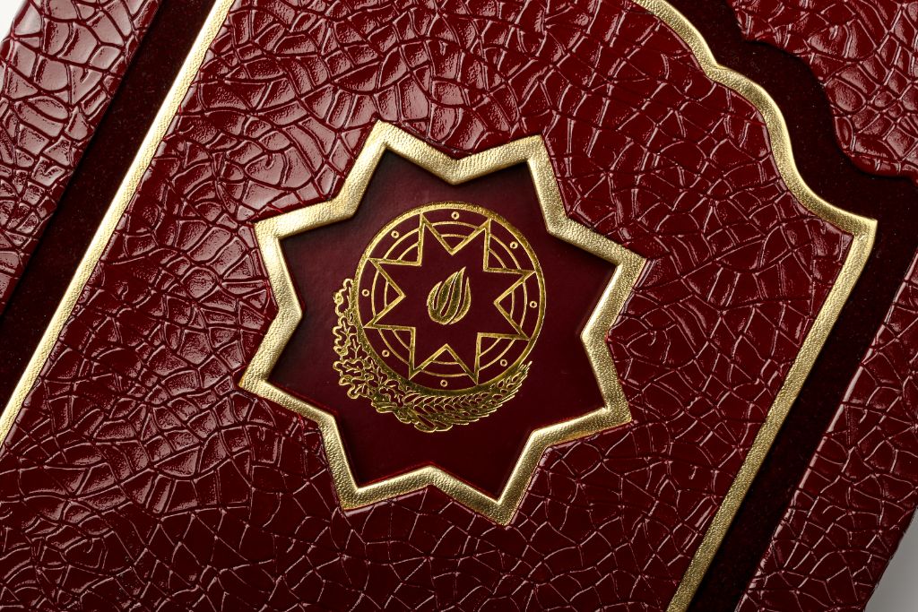 Crocodile folder — gold frame and coat of arms close-up