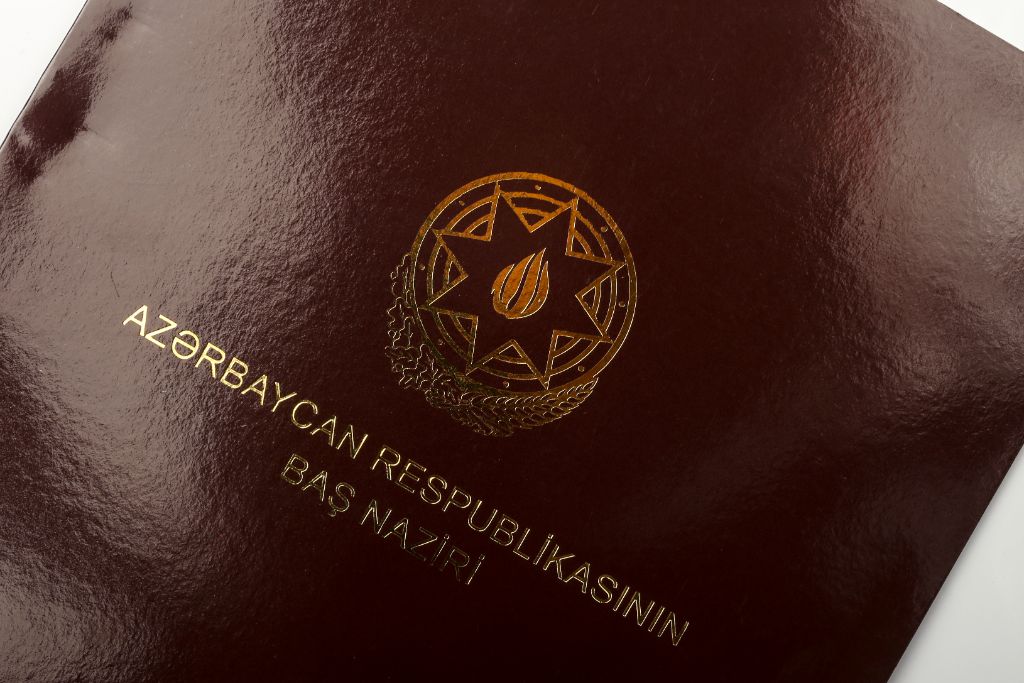 PM Folder — gold foil coat of arms close-up