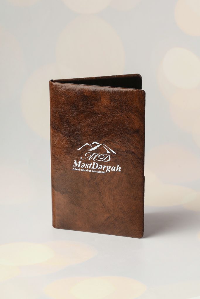 MəstDərgah menu cover — leather menu folder with logo, full view