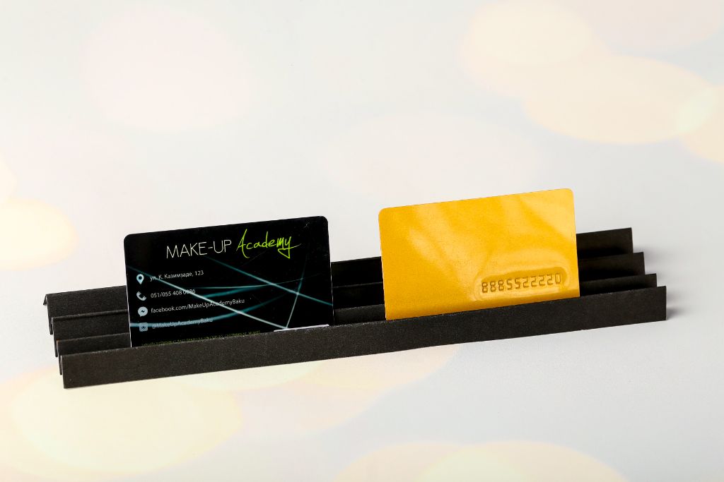 Make-Up Academy plastic cards — black with laser pattern and gold with embossed number, in holder
