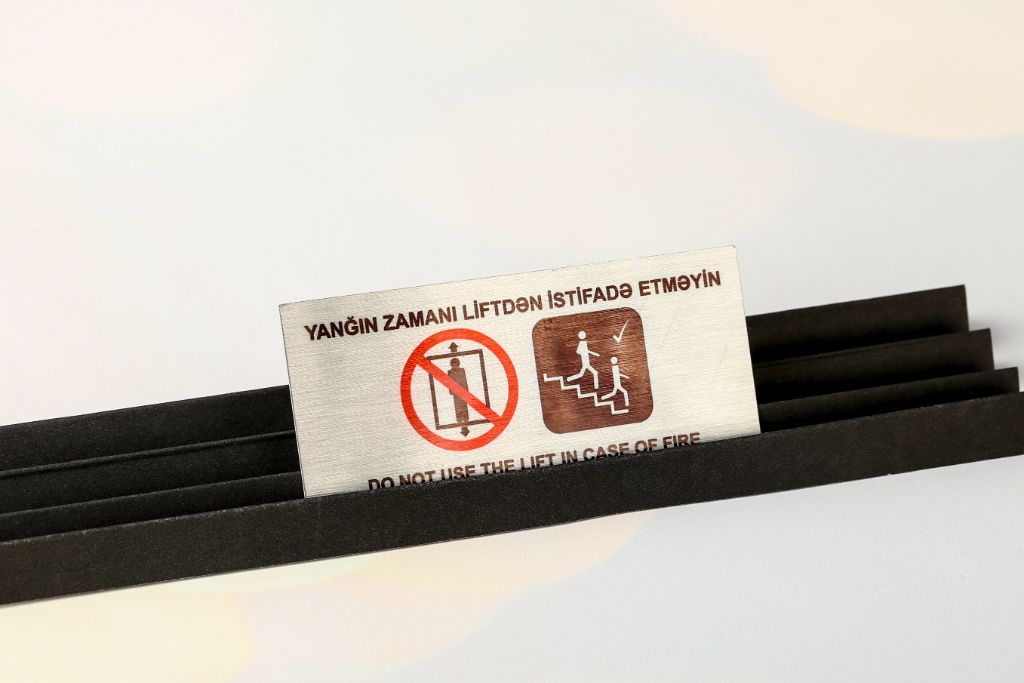 Information sign — Do Not Use Lift in Case of Fire, anodised aluminium with full-colour UV print and engraving