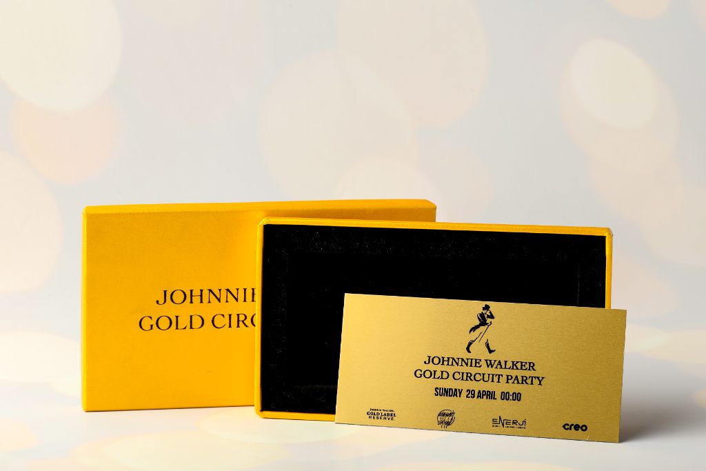 Johnnie Walker Gold Circuit Party — open yellow box and gold invitation card