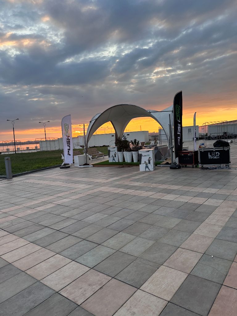 Baku sunset — Push brand dome tent and feather flags at waterfront