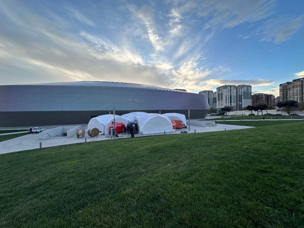 INMerge 2024 dome tents at dusk — Baku Convention Center exterior setup