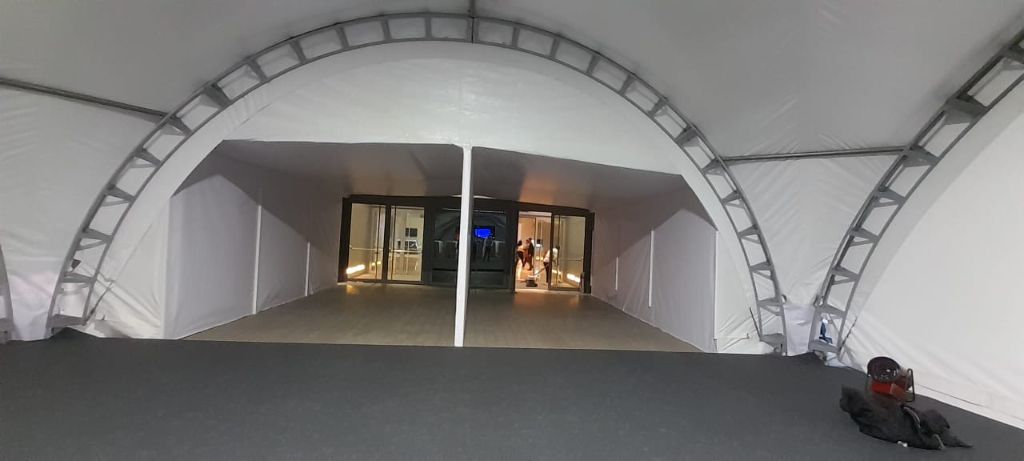 INMerge 2024 dome tent at night — arch entry from inside view