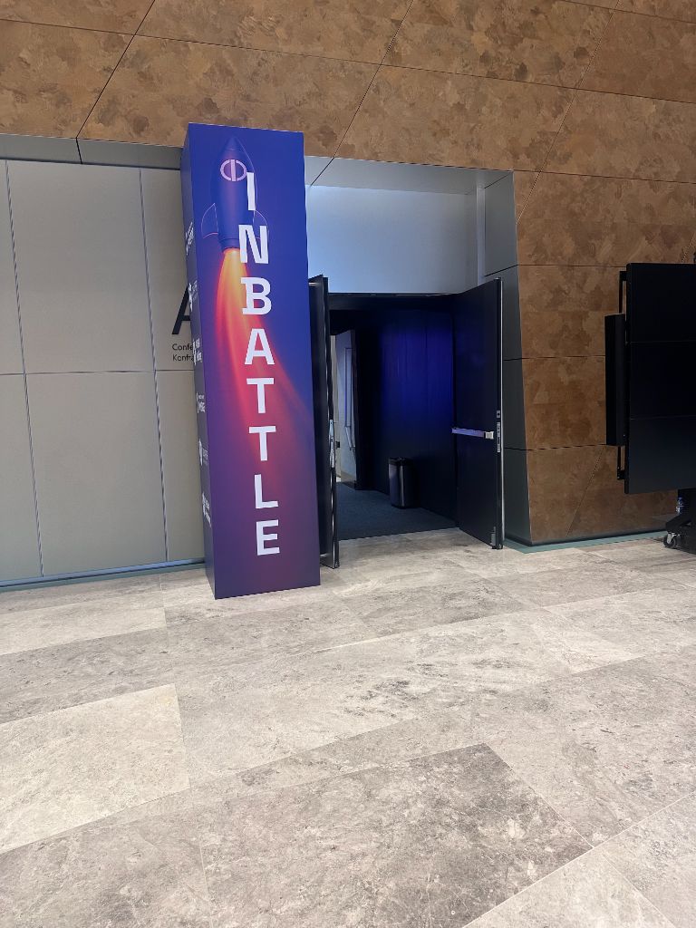 INMerge 2024 InBattle zone entrance — rocket graphic, purple blue totem