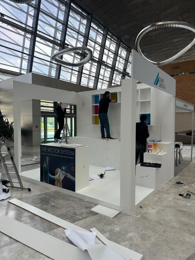 Dürr Dental stand under construction with workers on scaffold