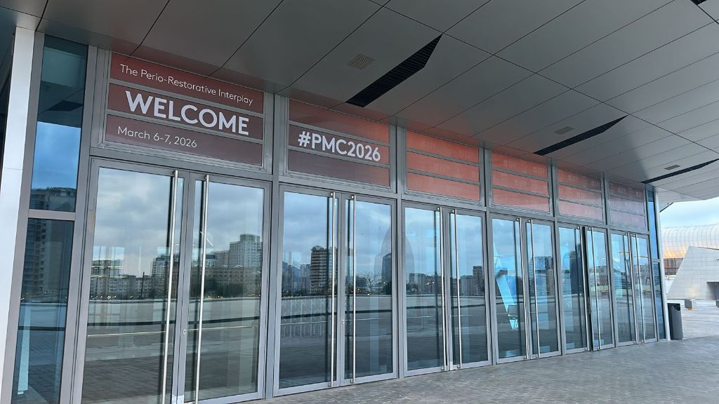 PMC2026 branded window graphics across entrance facade
