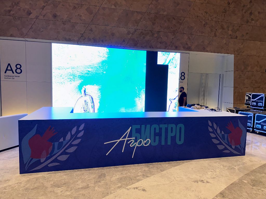 AgroBistro zone with large LED screen and branded counter