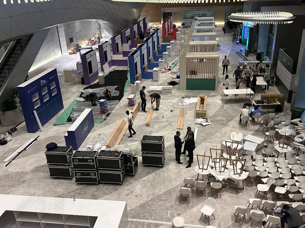 Late-stage construction — pavilion frames and finishing works in progress
