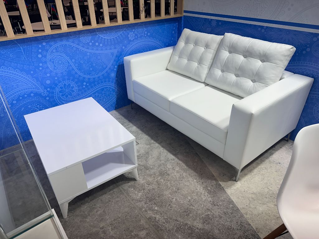 Meeting zone inside pavilion — white sofa lounge area